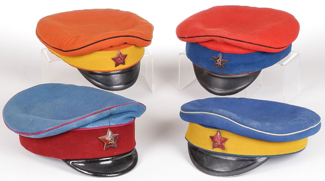 4 EARLY OR EARLY STYLE SOVIET RED ARMY CAVALRY: 4 EARLY OR EARLY STYLE SOVIET RED ARMY CAVALRY VISOR CAPS. Each of piped and banded cloth bodies of varying colors designating units and each with enameled red star above visor, one example stamped on