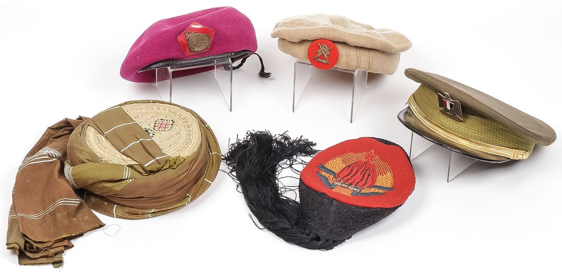 LOT OF FIVE FOREIGN HEADGEAR: LOT OF FIVE FOREIGN HEADGEAR. Comprising an Iraqi officer's visor cap, an Indonesia beret, a Pakistani Dir Levies pakol, a Yugoslav communist ceremonial hat (Lika cap), and another hat overall embroid