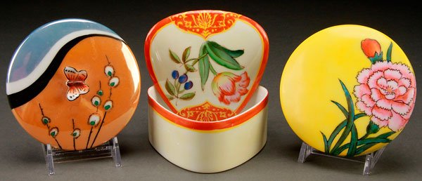 3 NORITAKE ART DECO PORCELAIN DRESSER BOXES: THREE HAND PAINTED NORITAKE ART DECO PORCELAIN DRESSER BOXES, EARLY 20TH CENTURY. Comprising a lidded powder box with butterfly handle, a triangular covered box with florals, and a round powder box wi