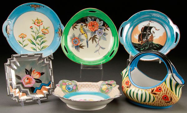 6 PIECES HAND PAINTED NORITAKE ART DECO PORCELAIN: A SIX PIECE HAND PAINTED NORITAKE ART DECO PORCELAIN GROUP, EARLY 20TH CENTURY. Comprising four handled plates/bowls, including a sailing galleon and parrot on floral branch, a silvered squared plate,