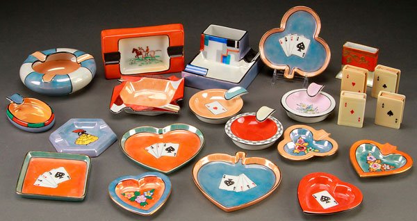 17 NORITAKE HAND PAINTED PORCELAIN SMOKING TOOLS: 17 NORITAKE HAND PAINTED PORCELAIN SMOKING ACCESSORIES, EARLY 20TH CENTURY. Comprising various shaped ash trays and bridge trays, together with four celluloid match covers. Assorted back stamps, mostl