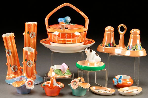 11 PIECES HAND PAINTED NORITAKE PORCELAIN: AN 11 PIECE HAND PAINTED NORITAKE ART DECO PORCELAIN GROUP, EARLY 20TH CENTURY. Comprising a three part tree trunk vase, a handled server with fruit finial, salt and pepper in handled tray, and variou