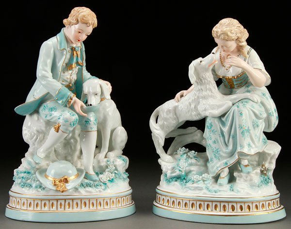 A PAIR OF VICTORIAN STYLE PORCELAIN FIGURAL VASES: A PAIR OF VICTORIAN STYLE PORCELAIN FIGURAL VASES, 20TH CENTURY. Modeled as a boy with dog and girl with dog. Height 15 inches (38 cm).