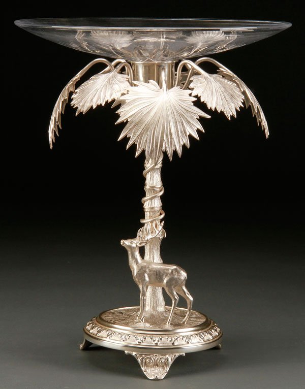 VICTORIAN STYLE SILVERED METAL & CRYSTAL COMPOTE: A VICTORIAN STYLE FIGURAL SILVERED METAL AND CRYSTAL COMPOTE, 20TH CENTURY. Depicting a stag below a spreading palm, surmounted with a crystal shallow bowl. Height 13 inches (33 cm), diameter 10.75 in