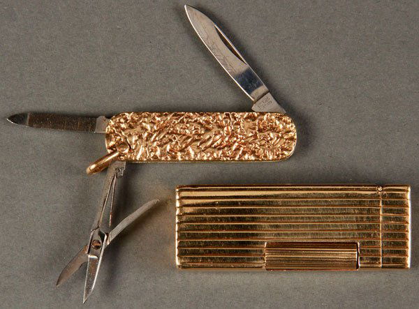 A MAN'S 14K GOLD DUNHILL LIGHTER AND PEN KNIFE: A MAN'S 14K GOLD DUNHILL LIGHTER AND PEN KNIFE, 20TH CENTURY. The lighter stamped 14K gold and inscribed "To Gretl my heart's delight- Robby". The pen knife with gold nugget handle and indistinguishab