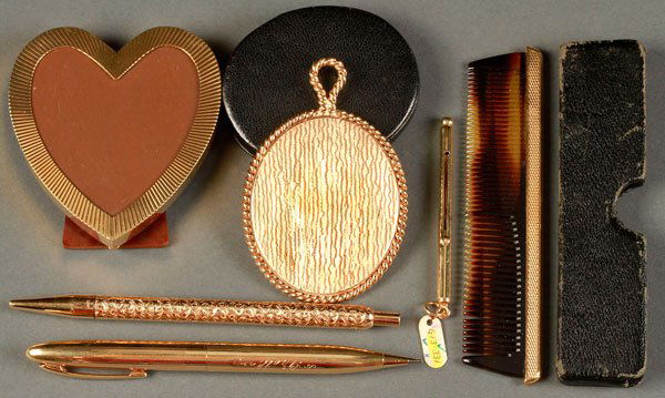 A SIX PIECE 14K GOLD GROUP, 20TH CENTURY: A SIX PIECE 14K GOLD GROUP, 20TH CENTURY. Comprising a leather cased 3 inch pocket mirror, a 3 inch heart shaped dresser frame, a leather cased pocket comb, a 14K ball point pen, a 14K mechanical pen