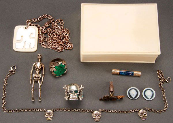 AN IVORY STERLING CUSTOM AND MACABRE JEWELRY LOT: AN IVORY STERLING CUSTOM AND MACABRE JEWELRY LOT, 20TH CENTURY. Comprising a man's silver and turquoise ring with overlapping leaf design, a silver skull and cross bones ring, a silver three skull nec