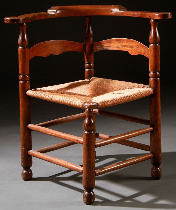 A COUNTRY SHERATON CORNER CHAIR: A COUNTRY SHERATON CORNER CHAIR, 19TH CENTURY. With woven rushed seat. Height 29.25 inches (74.25 cm).