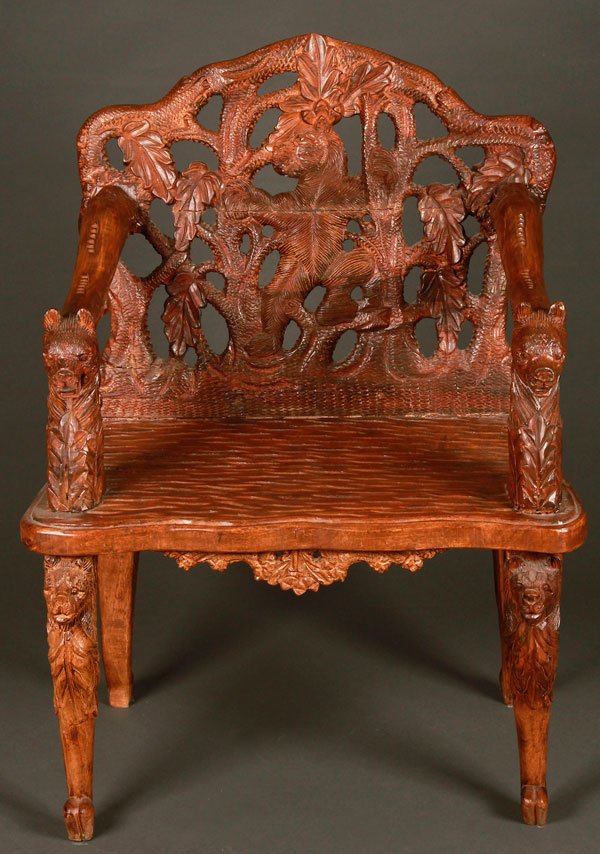A BLACK FOREST STYLE CARVED ARMCHAIR: A BLACK FOREST STYLE CARVED ARMCHAIR, LAST HALF 20TH CENTURY. With figural carved bears. Height 40 inches (101.5 cm), width 28.5 inches (73 cm), depth 22.5 inches (57 cm).