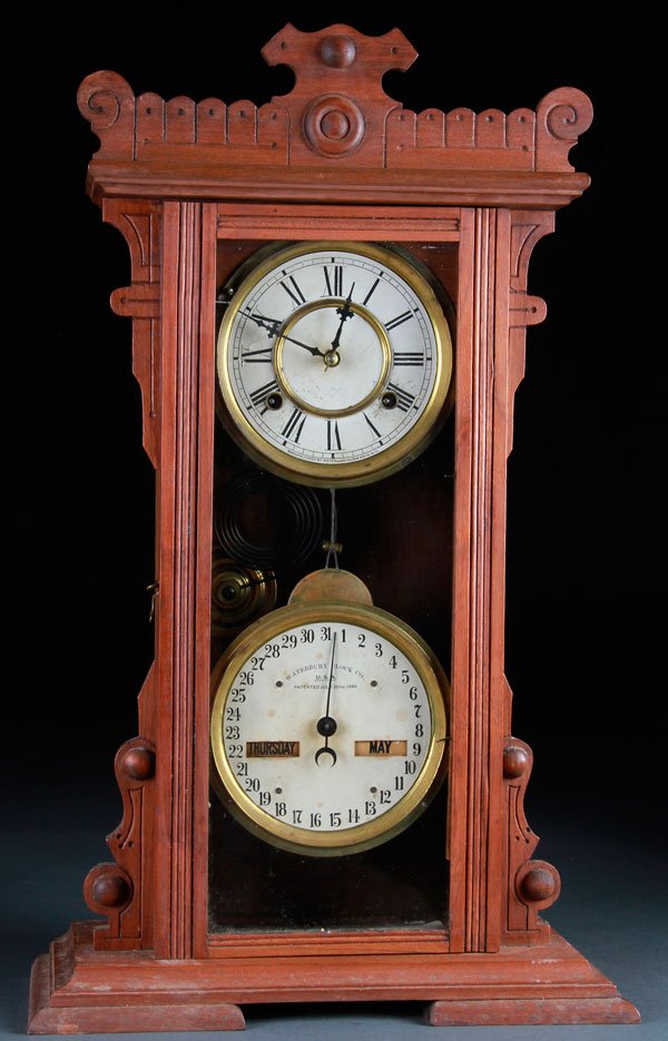 FINE WATERBURY VICTORIAN WALNUT CALENDAR CLOCK: A FINE WATERBURY VICTORIAN WALNUT CALENDAR SHELF CLOCK. With eight day movement and perpetual calendar dial for date, day and month. Height 24 inches (61 cm).