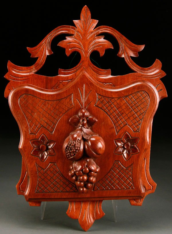 A VICTORIAN CARVED WALNUT WALL POCKET: A VICTORIAN CARVED WALNUT WALL POCKET. With fruit cluster decoration. Height 18.5 inches (47 cm).