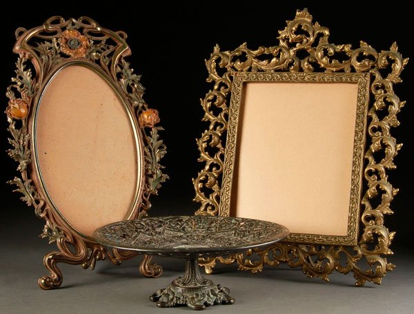 A THREE PIECE VICTORIAN BRONZE TABLEWARES GROUP: A THREE PIECE VICTORIAN BRONZE TABLEWARES GROUP. Comprising an Art Nouveau standing frame, a rococo style gilt frame, and a reticulated Renaissance style footed bowl. Largest height 17 inches (43 cm).