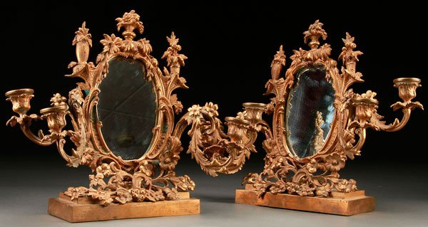 FRENCH LOUIS XV STYLE GILT BRONZE CANDELABRA: A PAIR OF FRENCH LOUIS XV STYLE GILT BRONZE MIRRORED TABLE TOP CANDELABRA, 19TH CENTURY. With scrolled foliate form mirror surrounds and four candle arms, each raised on reticulated foliate rectangula