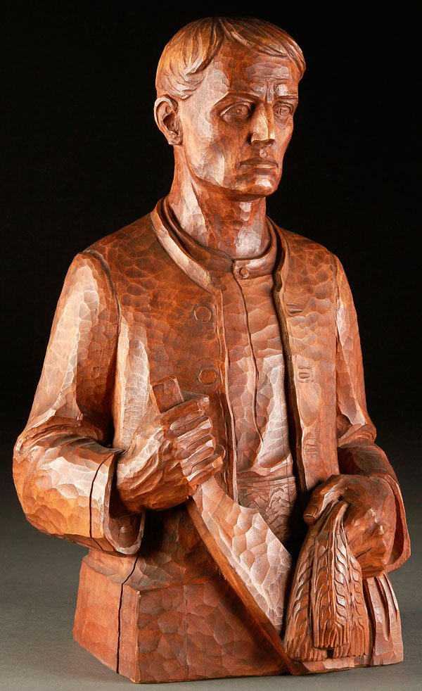 NAZI GERMANY THIRD REICH ART CARVED WOOD, CIRCA 1935: A GERMAN CARVED WOOD FIGURE OF A GLEANER, CIRCA 1935. The half-length figure depicting a Bavarian or South German farmer holding a bundle of wheat and edged tool- perhaps the personification of Labo
