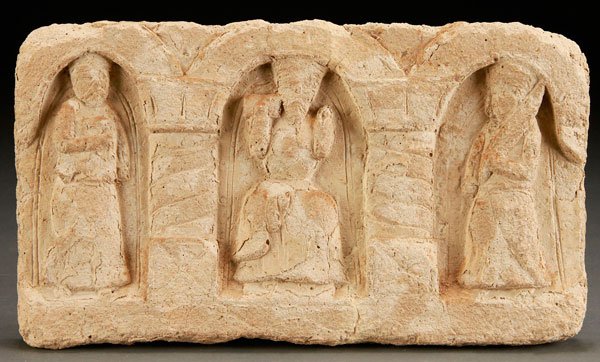 A NORTHERN AFRICAN CARVED LIMESTONE COPTIC STELE: A NORTHERN AFRICAN CARVED LIMESTONE COPTIC STELE, PROBABLY 1ST CENTURY AD. With later restorations to surface details. Depicting three standing figures within curved arch porticos. Length 14.5 inches