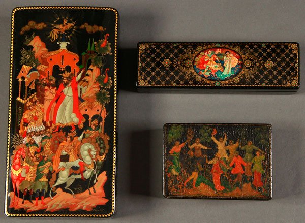 THREE RUSSIAN LACQUER BOXES, PALEKH AND KHOLUI: THREE RUSSIAN LACQUER BOXES, PALEKH AND KHOLUI, SIGNED, CIRCA 1940-2000. Comprising a large rectangular box with hinged lid illustrating "The Golden Rooster", artist signed in Cyrillic, 9 inches x 4.7