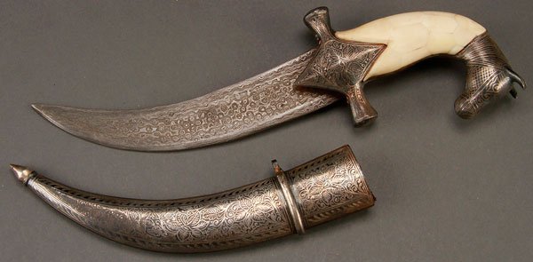 IRAQI DAMASCUS DAGGER: IRAQI DAMASCUS DAGGER. Double edged Damascus steel blade with Islamic cartouche. The guard nielloed and the handle comprised of bone tiles and with horse-head pommel also nielloed. The silvered metal 