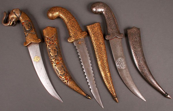 INDO-PERSIAN DAGGERS AND KNIVES, A GROUP OF FIVE: INDO-PERSIAN DAGGERS AND KNIVES, A GROUP OF FIVE. Comprising three Damascus and nielloed daggers, the first with slightly curved Damascus blade, elephant head pommel and the handle and matching scabba