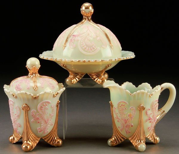 CUSTARD GLASS INVERTED FAN AND FEATHER TABLEWARES: A THREE PIECE CUSTARD GLASS "INVERTED FAN AND FEATHER" TABLE SETTING, 19TH CENTURY. Comprising a covered butter, covered sugar, and creamer. Largest height 6.75 inches (17 cm), diameter of dish 7.5 in