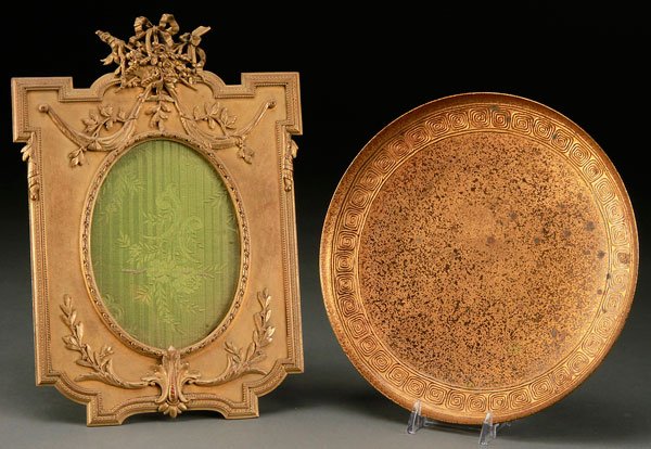 A TIFFANY STUDIOS "ETCHED METAL" GILT BRONZE TRAY: A TIFFANY STUDIOS "ETCHED METAL" GILT BRONZE TRAY, CIRCA 1900. Number 1743. Together with a French Louis XVI style gilt bronze picture frame with embossed floral basket crest. Height 10.25 inches (26 