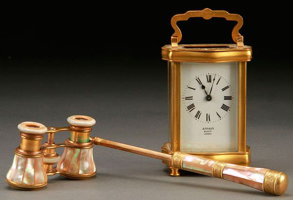 A VICTORIAN OPERA GLASS AND CARRIAGE CLOCK GROUP: A VICTORIAN OPERA GLASS AND CARRIAGE CLOCK GROUP, LATE 19TH/EARLY 20TH CENTURY. Comprising a pair of French mother of pearl "LEFILS" and gilt bronze mounted opera glasses with extending handle and an