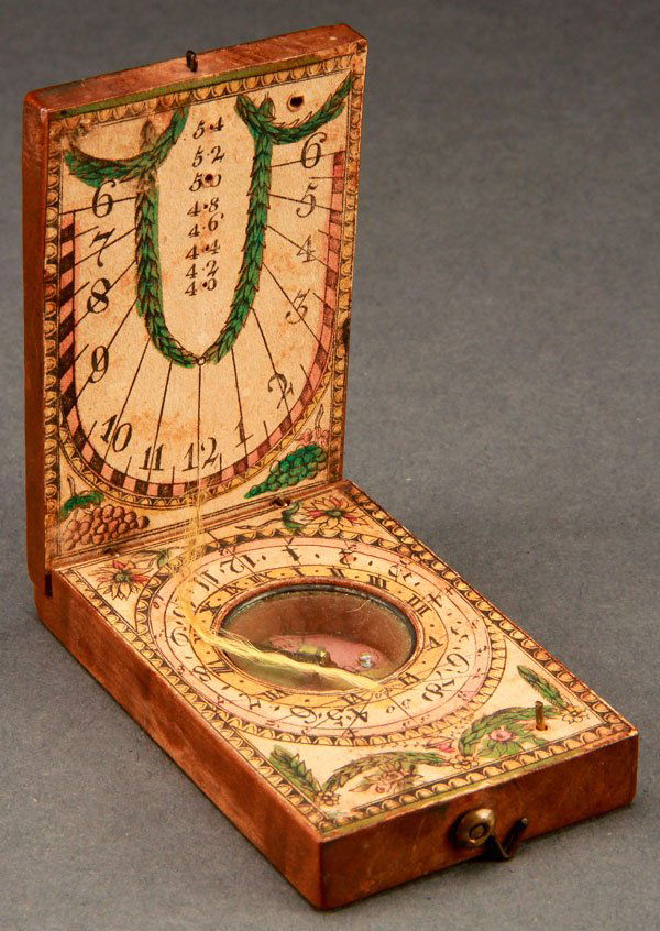 GERMAN FRUITWOOD FOLDING DIPTYCH COMPASS/SUNDIAL: A GERMAN FRUITWOOD FOLDING DIPTYCH COMPASS/SUNDIAL, CIRCA 1800. With polychrome printed paper facings and numerical markings. Indicator silk detached. Length 2.75 inches (7 cm).