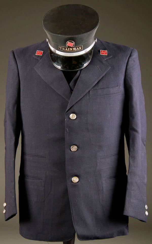 RAILROAD TRAIN MAN'S UNIFORM FOR MILWAUKEE ROAD: A "MILWAUKEE ROAD" TRAIN MAN'S UNIFORM, MID 20TH CENTURY. Comprising a Carlson and Company three button jacket, vest, trousers and cap. The buttons embossed CMST.P&P. The lapels with red enameled Milw