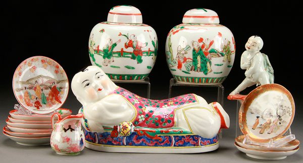CHINESE AND JAPANESE HAND PAINTED PORCELAIN: A 15 PIECE GROUP OF CHINESE AND JAPANESE HAND PAINTED PORCELAIN. Including a pair of Doucai style lidded jars, a figural porcelain head rest, length 10.75 inches (27.3 cm); Japanese Kutani saucers, a 