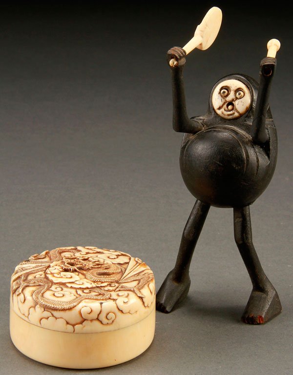 A FINE JAPANESE CARVED IVORY GROUP, CIRCA 1900: A FINE JAPANESE CARVED IVORY GROUP, CIRCA 1900. Comprising a covered round box with dragon and stylized cloud forms, and an ivory and hardwood carved Kobe with extending eyes and tongue. Height of fig