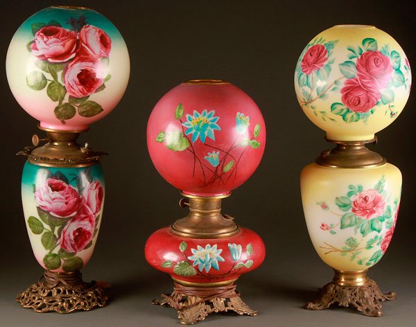 3 VICTORIAN GONE WITH THE WIND STYLE LAMPS: THREE VICTORIAN GONE WITH THE WIND STYLE LAMPS, 19TH CENTURY. Each with matching hand painted shades and fonts with floral decoration. The first two with later electrification. Largest height 26 inche
