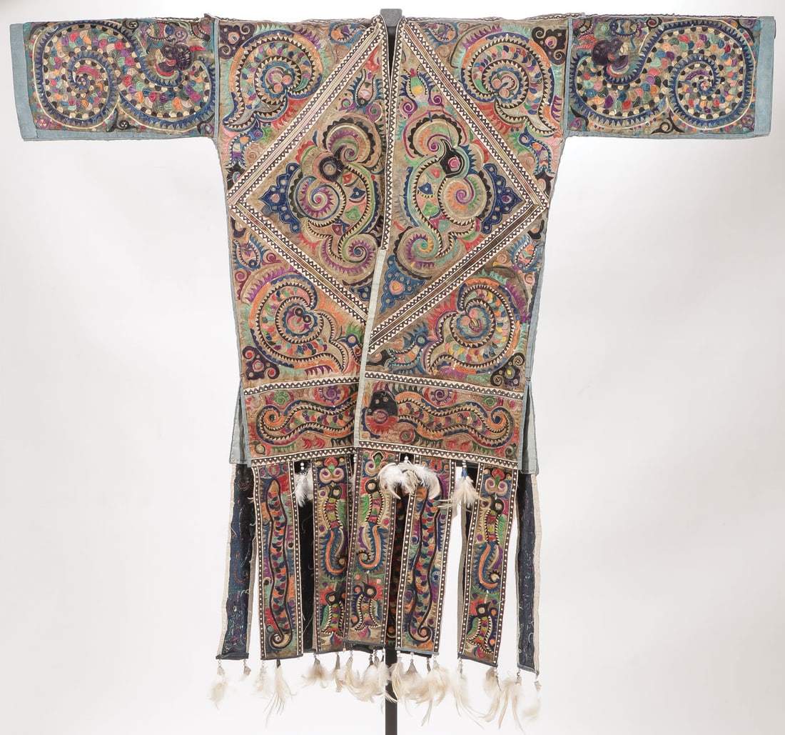MIAO CEREMONIAL EMBROIDERED ROBE: MIAO CEREMONIAL EMBROIDERED ROBE. Of traditional form, overall profusely embroidered in varicolored silk thread, depicting birds (100 birds style) and florals, with feather-decorated fringe. Width wit