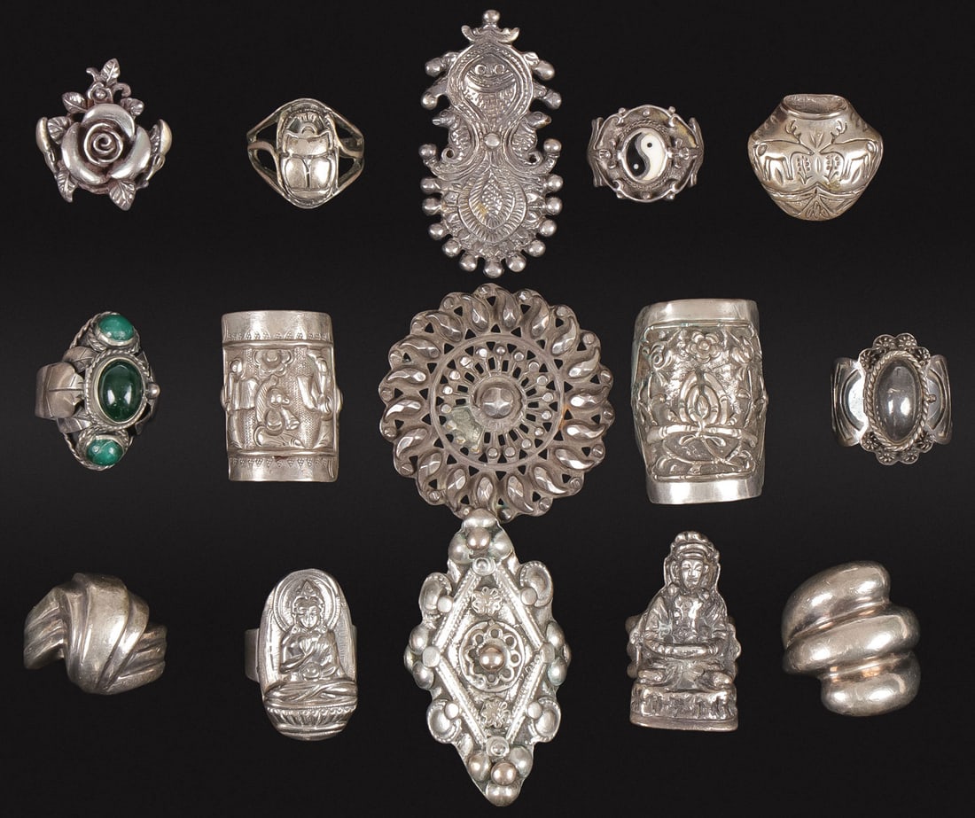 14 SILVER ASIAN/BUDDHIST RINGS & OTHERS: 14 SILVER ASIAN/BUDDHIST RINGS & OTHERS. Including a variety of shapes, designs, and motifs. Most likely silver. Some with polished cabochon stones as shown, and including an American southwest exampl