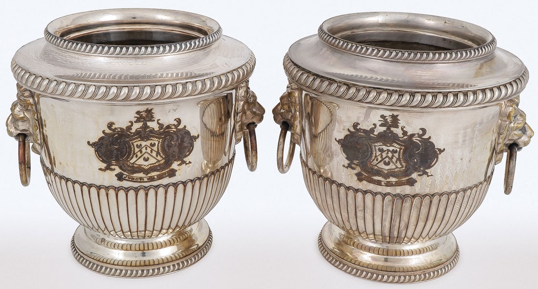 PAIR OF GEORGIAN SILVER-PLATED WINE COOLERS: PAIR OF GEORGIAN SILVER-PLATED WINE COOLERS. Comprising a pair of English silver-plated wine coolers, of urn form, engraved with coat of arms and motto "Juncti Valemus," with lion's head ring handles,