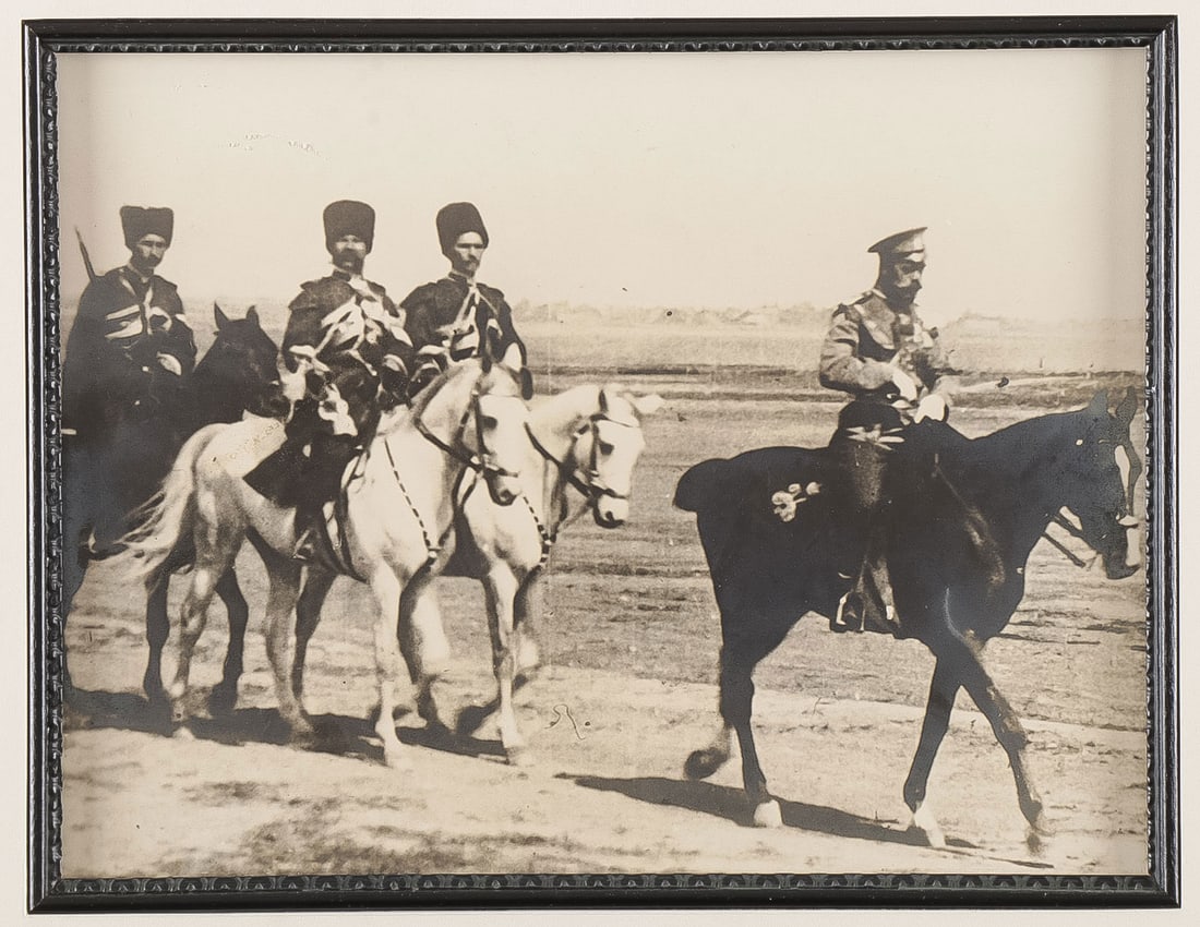 GROUP OF IMPERIAL RUSSIAN PHOTOGRAPHS: GROUP OF IMPERIAL RUSSIAN PHOTOGRAPHS. Comprising an albumen photograph of Nicholas II reviewing troops on horseback 7.25 x 9.5 inches (18.5 x 24cm). A photograph of Alix and Nicholas after W&D. Downe
