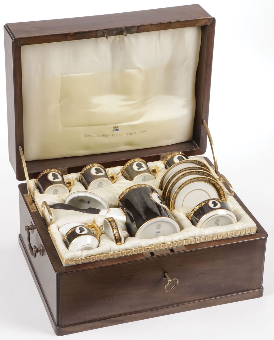 ROYAL COPENHAGEN COLONIAL COFFEE SERVICE: ROYAL COPENHAGEN COLONIAL COFFEE SERVICE. In the original fitted silk-lined wood chest, comprising a coffee pot, four cups (one with damage, as shown) and saucers, a creamer, a sugar, and a serving tr