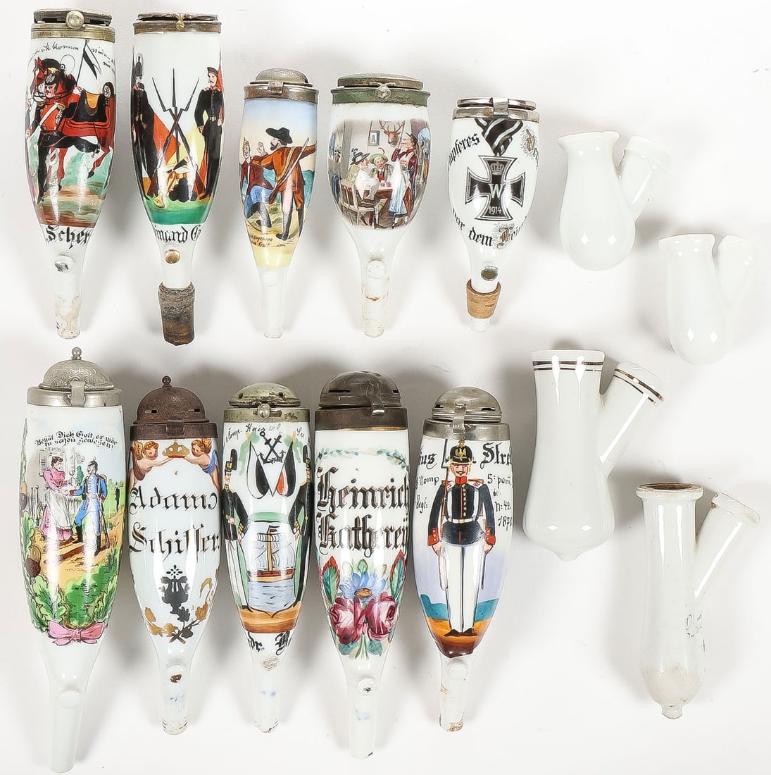GOOD IMPERIAL GERMAN RESERVIST PIPE GROUP: GOOD IMPERIAL GERMAN RESERVIST PIPE GROUP. Comprising 10 loose bowls, a variety of wood and ornamented stems, some with porcelain bowl holders, and a complete pipe with named pipe bowl and pickelhaube