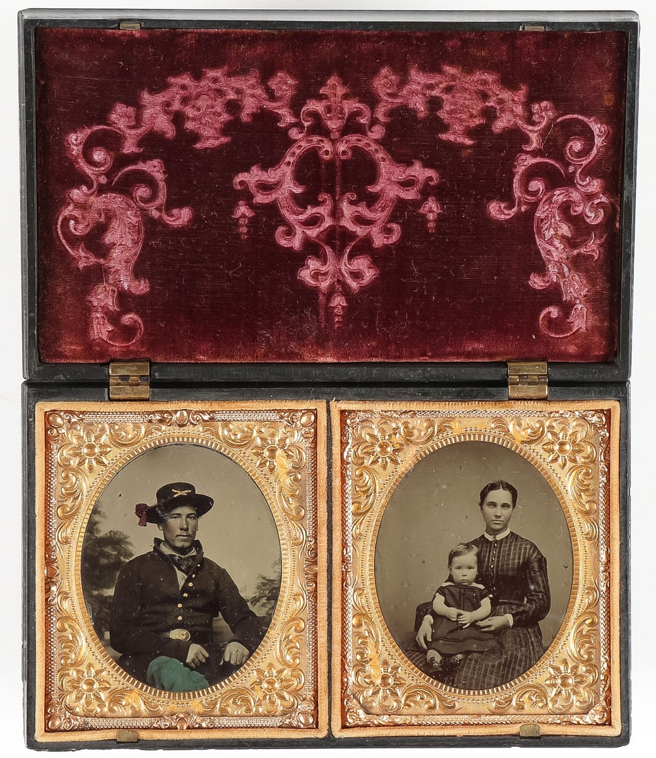 CIVIL WAR TINTYPE & UNION CASE: CIVIL WAR TINTYPE & UNION CASE. Comprising a large 4 x 6.25-inch Union case, the hinged cover with relief-sculpted mother and child with dog, containing a tinted 1/6 plate depicting a seated Union sol