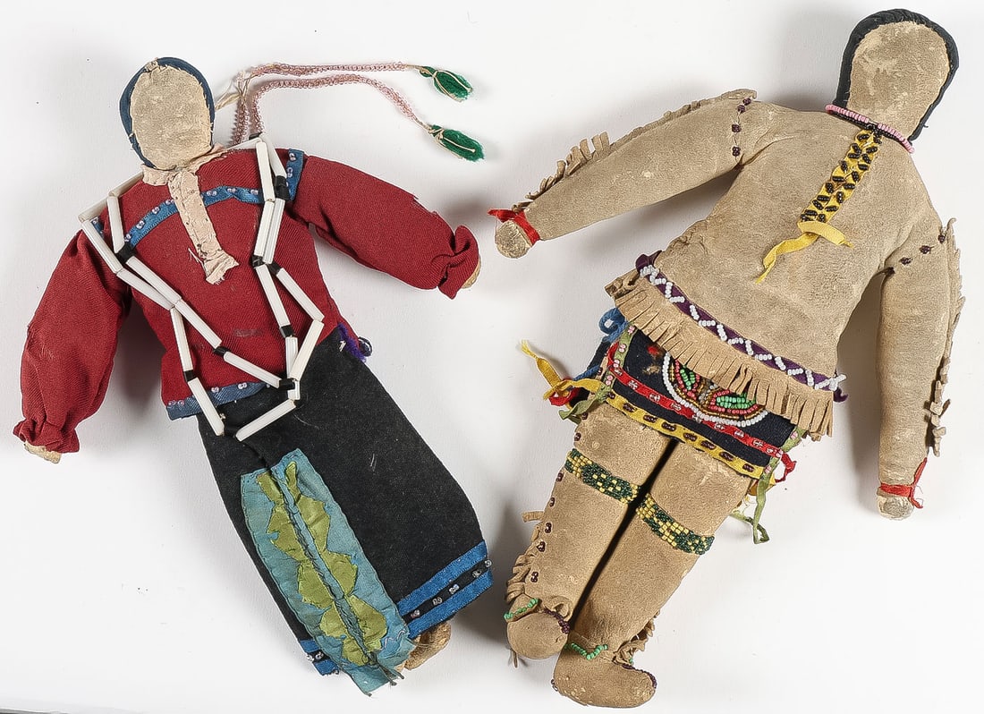 PAIR OF VINTAGE NATIVE AMERICAN DOLLS, 19TH C: PAIR OF VINTAGE NATIVE AMERICAN DOLLS, 19TH C. Comprising an original Ho-Chunk or Sauk doll with beaded hair drops, silk ribbon banding, and glass tube necklace, height 9.75 inches. Together with a ve