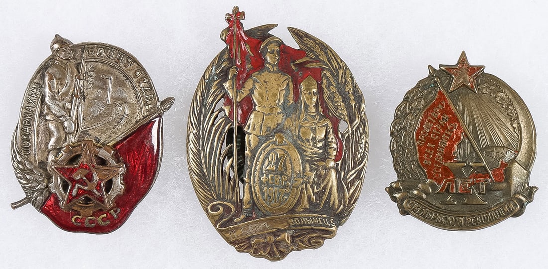 3 GOOD EARLY SOVIET BADGES: 3 GOOD EARLY SOVIET BADGES. Comprising a silver-plated screw-back and post enameled badge, "To a Warrior of the OKDVA," numbered on verso 1309, height 42mm. Together with a screw-back enameled badge o