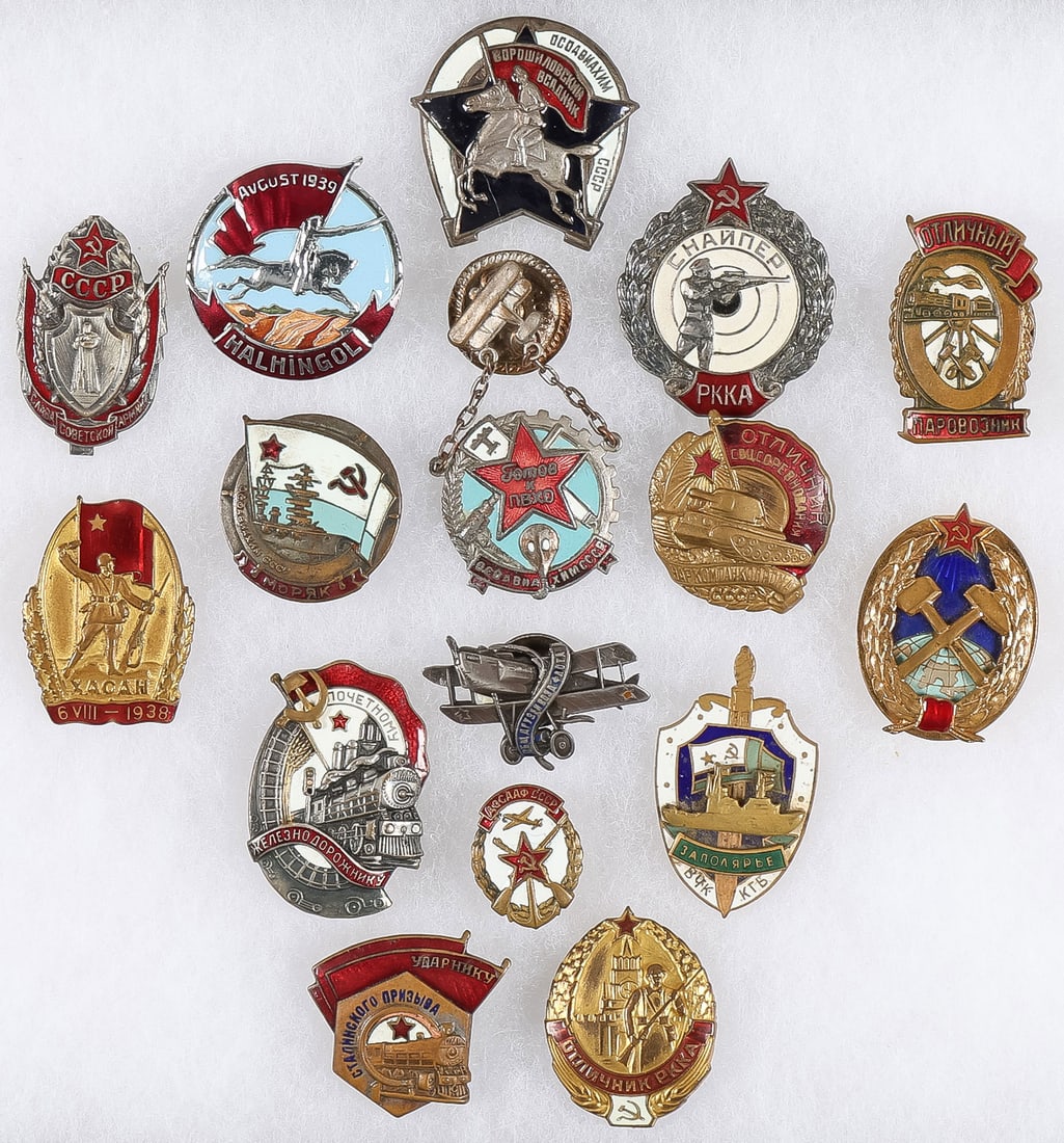 16 GOOD SOVIET BADGES: 16 GOOD SOVIET BADGES. From top to bottom, left to right: a Voroshilov Horseman Badge, a Khalkhin Gol badge, a Red Army Sniper Badge, a Glory to the Soviet Army badge, an excellent Locomotive Engineer