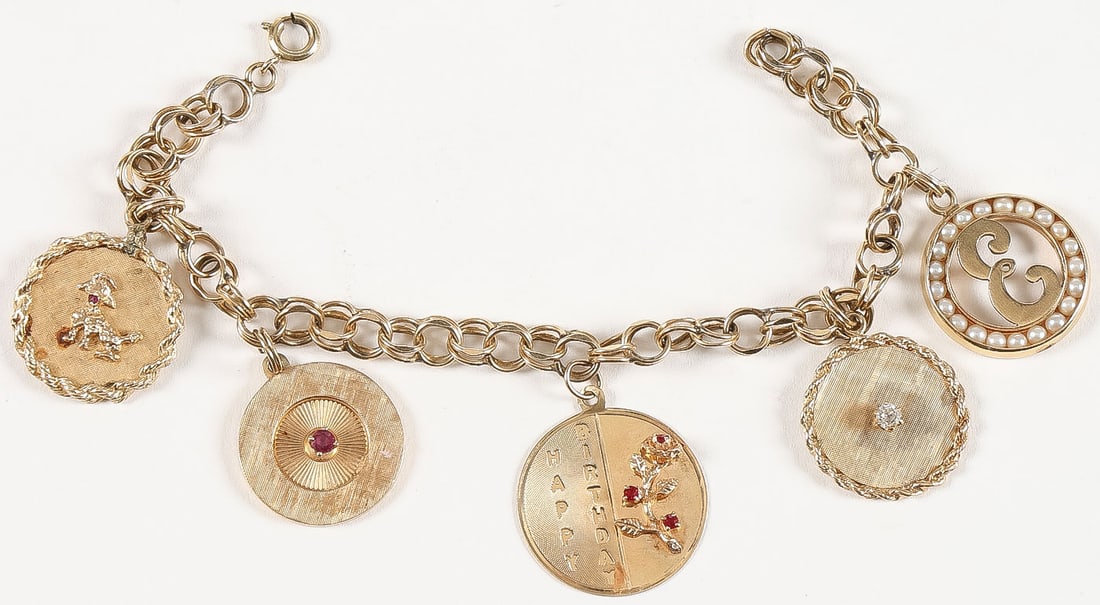14K GOLD CHARM BRACELET: 14K GOLD CHARM BRACELET. Comprising a 14K gold charm bracelet, one charm disc with single diamond, one with ruby, one with rubies in tree form, and another set with seed pearls as shown. Total weight
