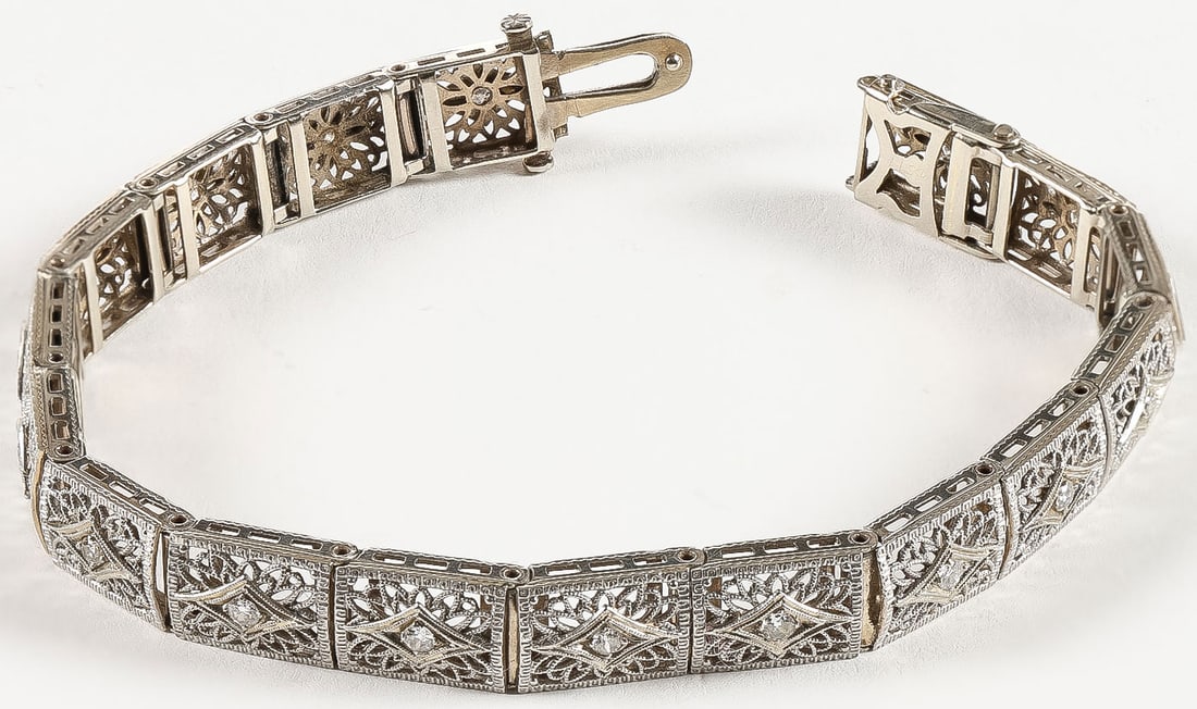 LADIES 14K GOLD & DIAMOND BRACELET: LADIES 14K GOLD & DIAMOND BRACELET. Comprising a vintage 14K gold filigree bracelet set with 17 accent diamonds. Length 7.25 inches (18.42cm). Total weight 16 grams.SHIPPING NOTICE:If you are not us