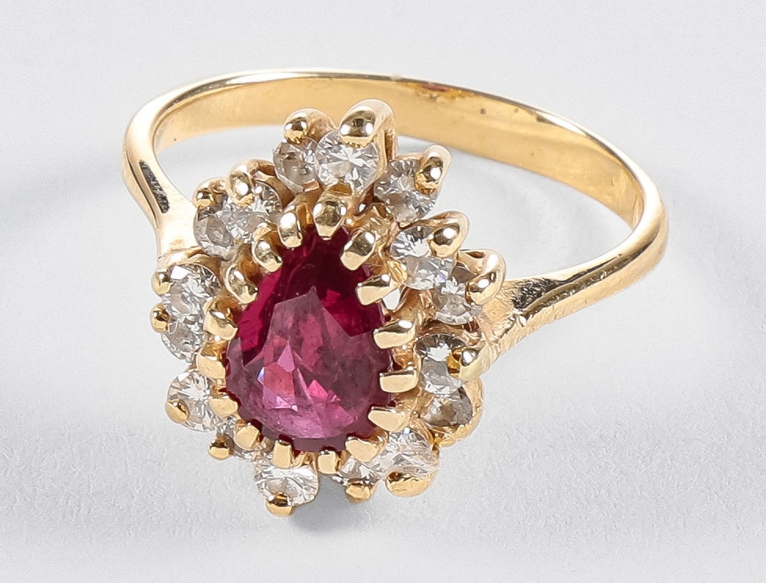 LADIES 14K GOLD, RUBY AND DIAMOND RING: LADIES 14K GOLD, RUBY AND DIAMOND RING. Comprising a gold halo-style ring set with an approximate 1ct pear-shaped natural ruby and an additional 16 full-cut accent diamonds. Approximate size 4½.