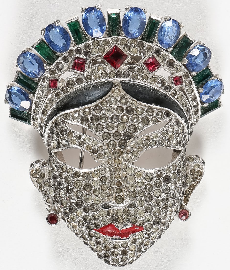 SIGNED MAZER ORIENTAL MASK BROOCH, C 1940: SIGNED MAZER ORIENTAL MASK BROOCH, C 1940. Comprising a great Art Deco-style "Oriental Mask" signed Mazer rhodium-plated brooch with rhinestone pavé, green, blue, and red stones, and black and re