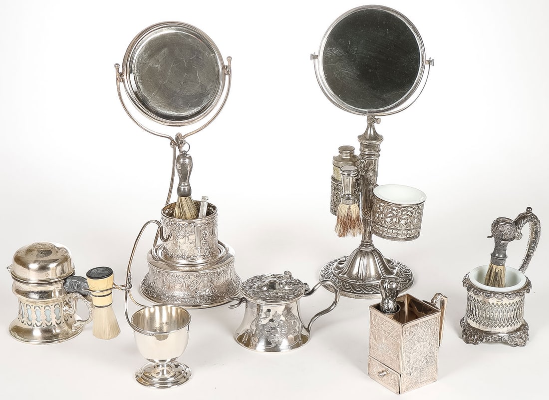 GREAT SILVER-PLATED SHAVING CUPS & MIRRORS: GREAT SILVER-PLATED SHAVING CUPS & MIRRORS. Comprising two swivel mirrors on stands, each incorporating a mug, one with powder tin holder, and each with brush holder and brush, together with a hinged