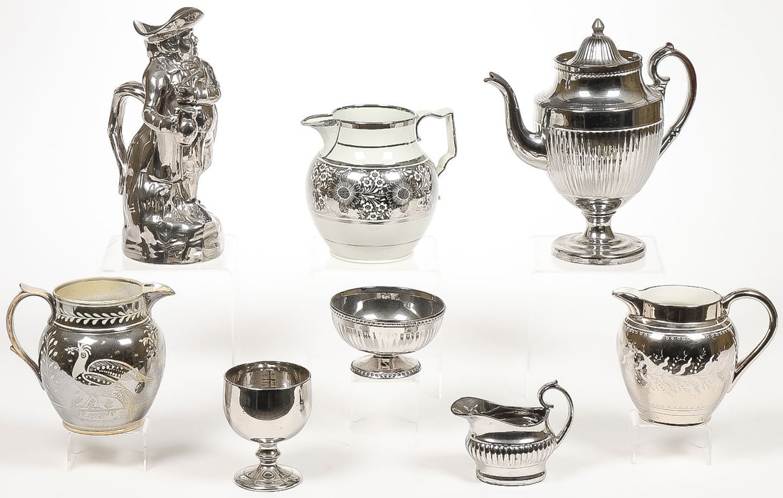 8 PCS ENGLISH SILVER LUSTERWARE: 8 PCS ENGLISH SILVER LUSTERWARE. Comprising a figural jug, teapot, pitchers, footed goblet, and others, as shown. Greatest height 11.5 inches.SHIPPING NOTICE:If you are not using the Live Auctioneer