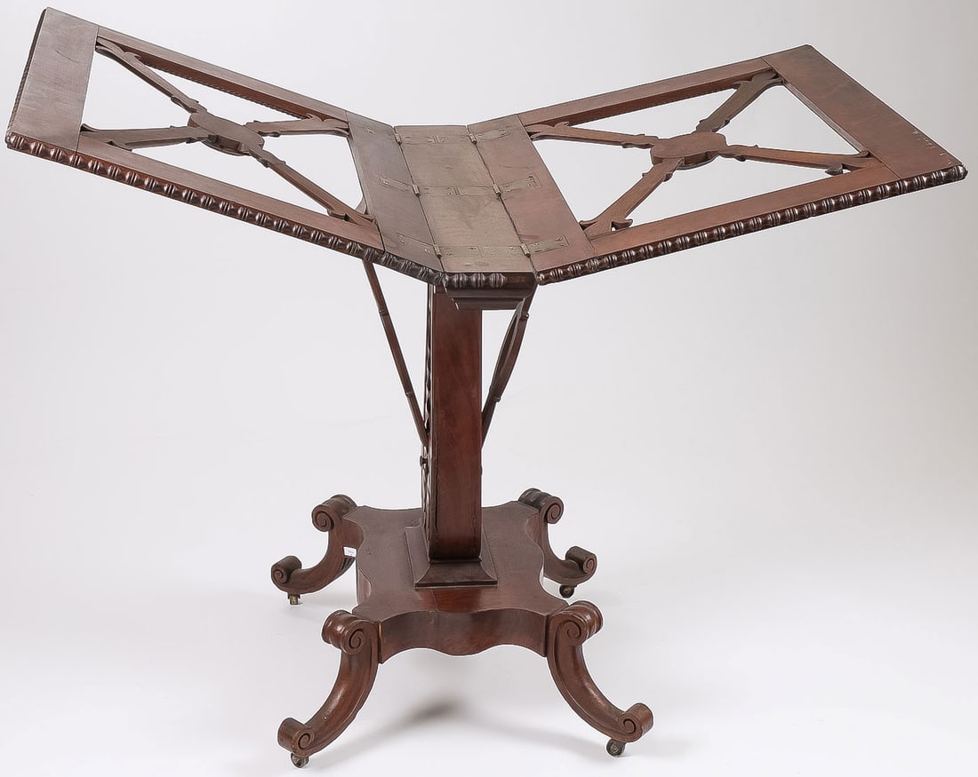 EXCEPTIONAL MAHOGANY FOLIO STAND, 19TH C: EXCEPTIONAL MAHOGANY FOLIO STAND, 19TH C. Comprising a very fine mahogany folio stand, circa 1830. Resting on 4 scroll legs set with castors with leaf carved pedestal supporting an openwork fold out f