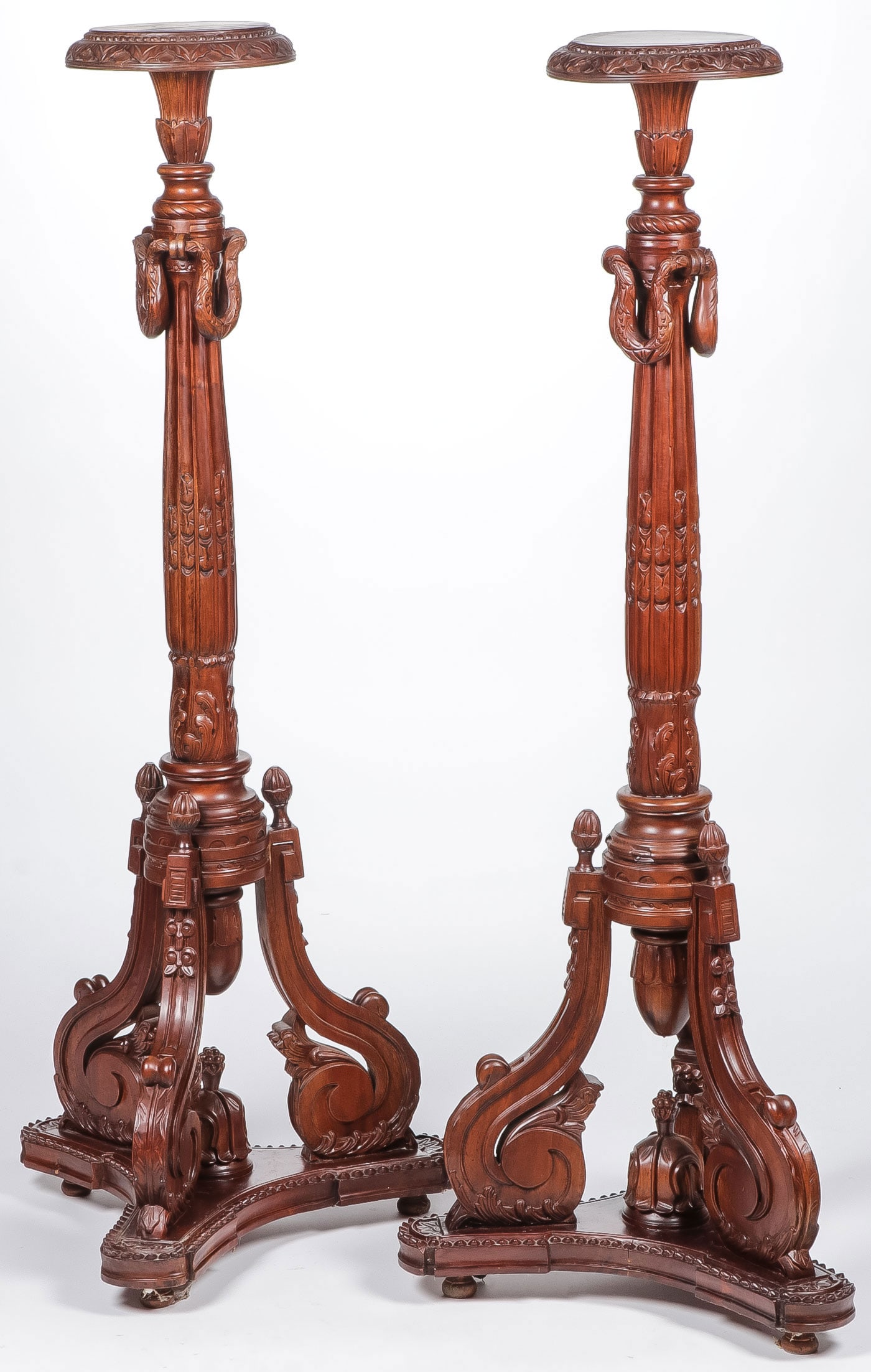 PR MATCHING CARVED PEDESTAL STANDS: PR MATCHING CARVED PEDESTAL STANDS. Ornately carved on trefoil bases with scroll brackets and carved swags. Height 57 inches, depth 22 inches. LOCAL PICK-UP OR 3RD PARTY SHIPPER ONLY.SHIPPING NOTICE: