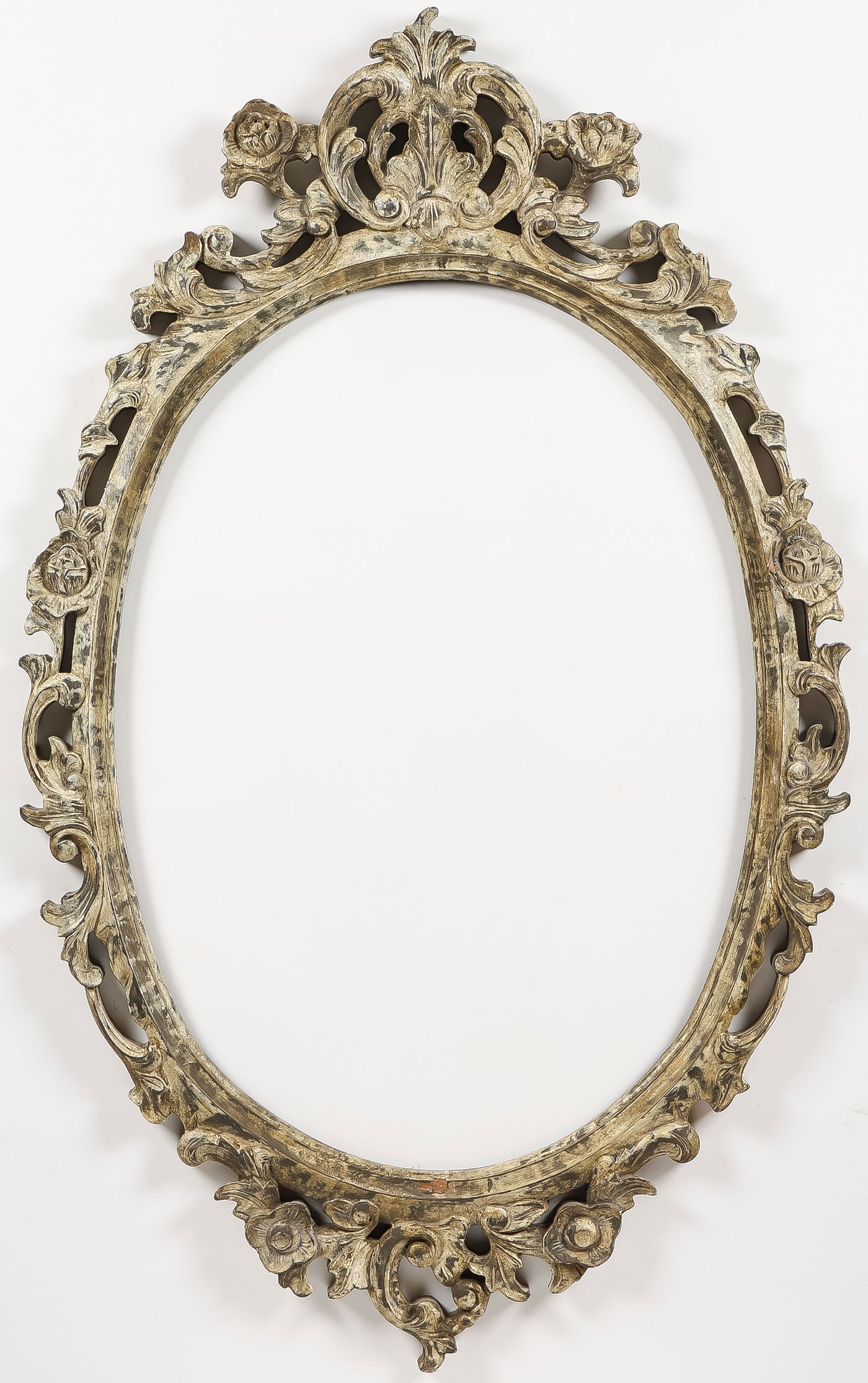 CARVED WOOD OVAL FRAME, 19th C: CARVED WOOD OVAL FRAME, 19th C. Comprising an ornate pierced carved wood oval frame, measuring 42.25 x 26.25 inches (107 x 66cm). Aperture 28 x 20 inches (71 x 51cm).SHIPPING NOTICE:If you are not u