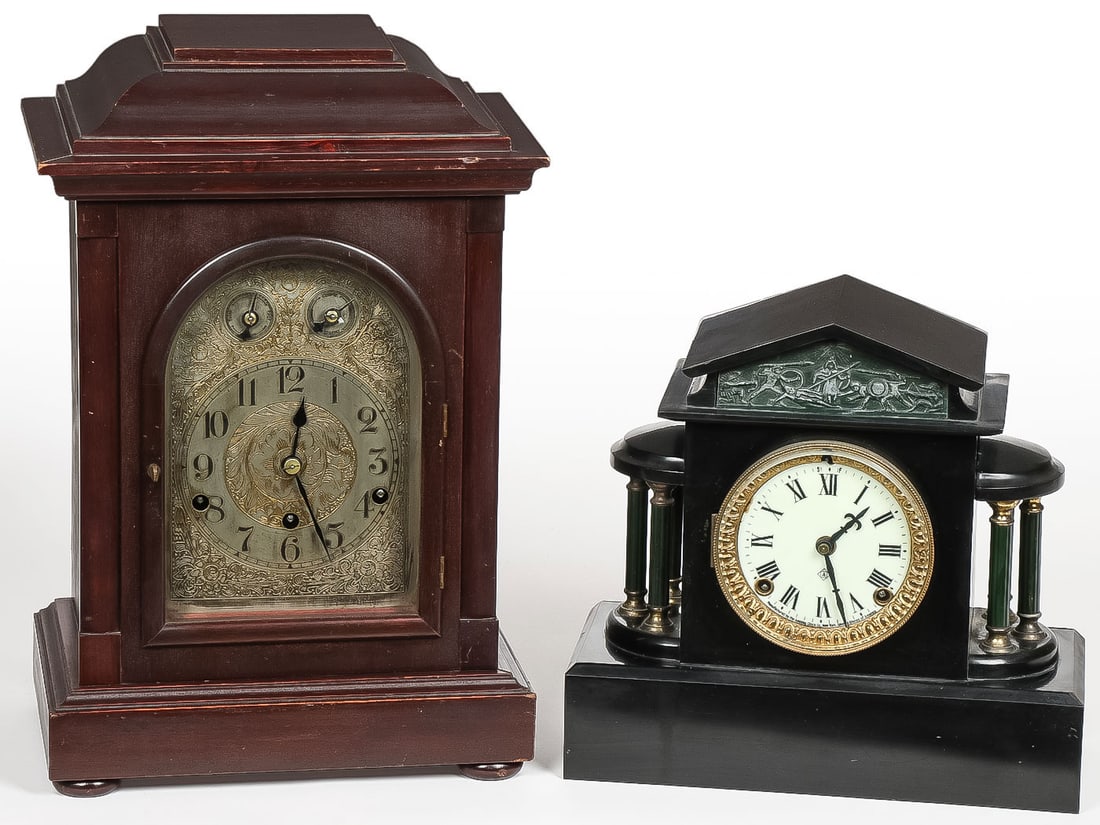 A PAIR OF MANTEL CLOCKS: A PAIR OF MANTEL CLOCKS. Including an attractive wooden-cased bracket clock with chimes, the works marked Kienzie. Together with an interesting Ansonia mantel clock with side columns and an ancient G